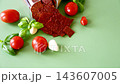 Spicy tomato pastila with garlic and basil on green background 143607005