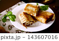 Traditional fried crepes with mushroom filling on rustic wooden table 143607016