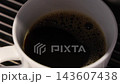 Pouring coffee slow motion footage. Close up white coffee cup. It captures pouring fresh coffee followed by hot water or milk. Create hot Americano Cappuccino or latte coffee. Fresh brew cafe concept 143607438