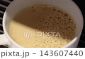 Pouring coffee slow motion footage. Close up white coffee cup. It captures pouring fresh coffee followed by hot water or milk. Create hot Americano Cappuccino or latte coffee. Fresh brew cafe concept 143607440