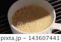 Pouring coffee slow motion footage. Close up white coffee cup. It captures pouring fresh coffee followed by hot water or milk. Create hot Americano Cappuccino or latte coffee. Fresh brew cafe concept 143607441