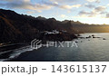 A drone flight along the Anaga cliffs reveals the white houses of Taganana perched above the sea. Village and coastline together for Tenerife travel storytelling. 143615137