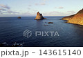 The Benijo sea stacks stand alone in open water seen from a drone pulled back over the Atlantic. A cleaner wide angle of Tenerife's most photographed rock formation. 143615140