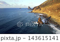 An overhead aerial takes in the full curve of the Benijo bay with its black sand shore and rock cluster. A wide island view built for travel and nature campaigns. 143615141