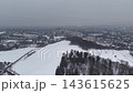 Snowy Aerial View Of Frozen River, Park Ranger Drone Survey Over Snowcovered Fields And Evergreen Stands, 143615625