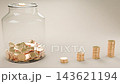 A video illustrating the concept of saving money: one gold coin is added to a glass bottle at a time, and the pile of coins next to it rises upwards to the right. 143621194