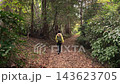 A slow-motion shot of a woman walking from behind on the Shibusawa Hills in autumn. 143623705