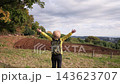 A female hiker's back as she takes a deep breath in the Shibusawa Hills. 143623707
