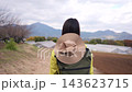 A dolly shot of a woman gazing at a hilly landscape. 143623715