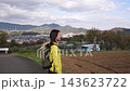 A dolly shot of a female hiker overlooking the scenery from Shibusawa Hills. 143623722
