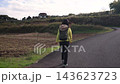 A follow shot of a female hiker walking along a path leading to the Shibusawa Hills. 143623723