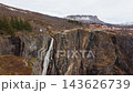 FPV drone flies above the gorge at Voringfossen and heads toward the valley, revealing steep canyon walls and a wider view of the Norwegian landscape. 143626739