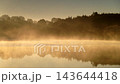 Morning fog over autumn lake water 143644418