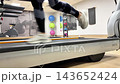 A person runs on a treadmill inside a gym, showing foot movement and exercise technique throughout the activity 143652424