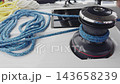 marine winch and ropes of sailing boat in the rain, rotation, yachtsman hands, sailor 143658239