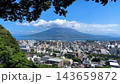 4K scenic video of Kagoshima city, Kinko Bay, and Sakurajima volcano as seen from Shiroyama Observatory in summer. 143659872