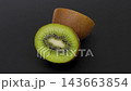 4K video of a beautiful cross-section of a kiwi fruit slowly rotating against a black background 143663854