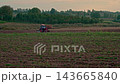 Red Tractor Driving Across Agricultural Field Medium Wide Shot 143665840
