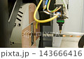 Automated CNC laser cutting machine processing a square metal pipe with bright 143666416