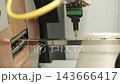 Automated CNC laser cutting machine processing a square metal pipe with bright 143666417