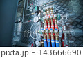 Close-up of a complex underfloor heating distribution manifold with PEX pipes 143666690