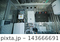 Modern mechanical room interior showing a complex HVAC system with heat pump 143666691