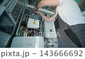 Modern mechanical room interior showing a complex HVAC system with heat pump 143666692