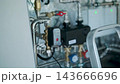 Modern mechanical room interior showing a complex HVAC system with heat pump 143666696