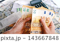 Man calculating money, monthly home expenses, taxes and bank account balance. 143667848
