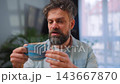 Happy man drinking coffee at relaxed home environment closeup. 143667870