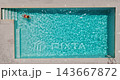 Aerial view of a woman in red swimsuit swimming in the pool. Summer lifestyle 143667872