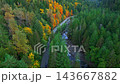 Top down view of car driving along the road among the autumn forest 143667882