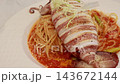 Grilled whole squid spaghetti pasta with tomato sauce on white plate. Grilled whole squid spaghetti pasta with tomato sauce on white plate. 143672144