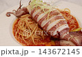 Grilled whole squid spaghetti pasta with tomato sauce on white plate. Grilled whole squid spaghetti pasta with tomato sauce on white plate. 143672145