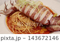Grilled whole squid spaghetti pasta with tomato sauce on white plate. Grilled whole squid spaghetti pasta with tomato sauce on white plate. 143672146