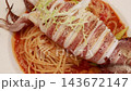 Grilled whole squid spaghetti pasta with tomato sauce on white plate. Grilled whole squid spaghetti pasta with tomato sauce on white plate. 143672147