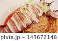 Grilled whole squid spaghetti pasta with tomato sauce on white plate. Grilled whole squid spaghetti pasta with tomato sauce on white plate. 143672148
