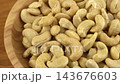 Cashews in a wooden bowl. Nuts are healthy food. Wooden background. Cashew kernel. 143676603