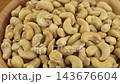 Cashews in a wooden bowl. Nuts are healthy food. Wooden background. Cashew kernel. 143676604