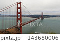 High angle view of the Golden Gate Bridge with traffic and boats in the bay on a cloudy day. 143680006