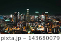 Nighttime aerial view of downtown Los Angeles skyline with illuminated skyscrapers and city lights 143680079