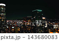 Nighttime aerial view of downtown Los Angeles showcasing city lights and illuminated skyscrapers in the urban skyline 143680083