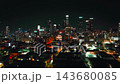 Los Angeles skyline at night with illuminated skyscrapers and city lights from an aerial perspective 143680085