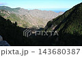 Deep shadowed valleys carve through the Anaga massif with the Atlantic Ocean pale on the horizon. A raw and remote corner of Tenerife for nature and adventure travel content. 143680387