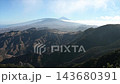 Layered Anaga ridges fold into the distance under a hazy Mount Teide seen from a high mountain viewpoint. Vast island scale for travel and nature documentary content. 143680391