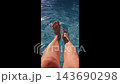 Sexy female legs splashing in clear water pool 143690298