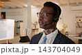 African man, call center and night in office with tech support, talking or listening with voip tech. Black consultant, headphones and microphone for customer service, advice or help in dark workplace 143704049