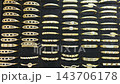 Rows of Gold-Tone Fashion Bracelets with Decorative Details 143706178