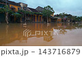 flooded city or town with buildings submerged in overflow water and mud, village underwater after heavy tropical rain and typhoon, consequences with dirt on the street 4k 143716879