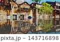 flooded city or town with buildings submerged in overflow water and mud, village underwater after heavy tropical rain and typhoon, consequences with dirt on the street 4k 143716898